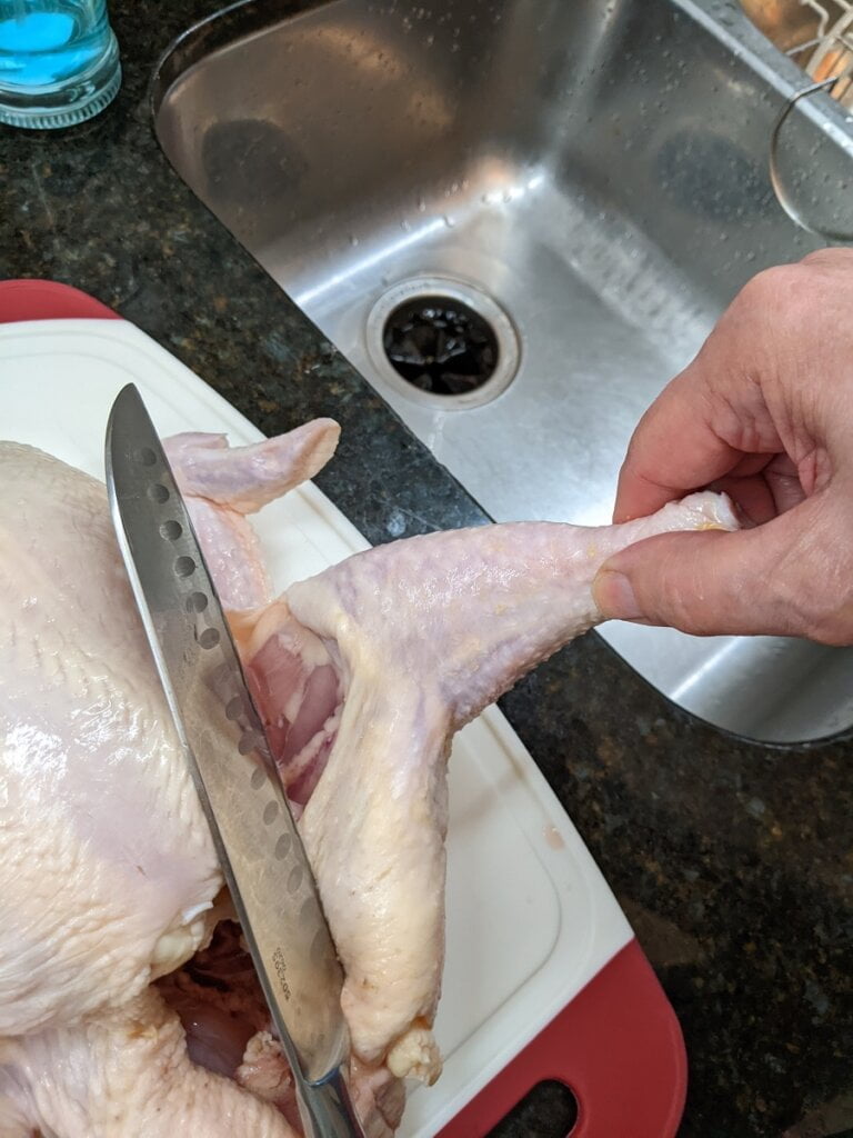 how to cut up a full chicken continuing with thigh