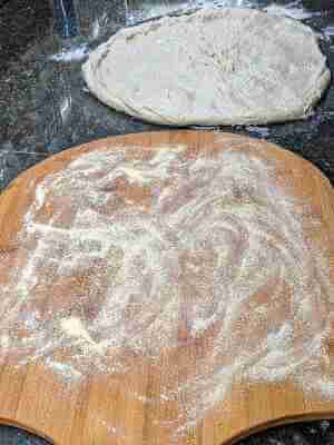 Preparing the pizza peel to receive pizza dough