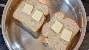 add butter to tops of cooking grilled cheese