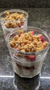 add granola topping to each cup for strawberry yogurt granola parfait recipe