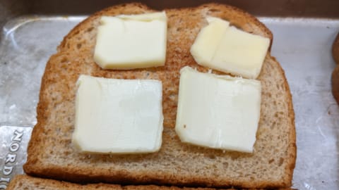 add thin butter slices to toast for next step of how to make cinnamon toast in the oven add thin butter slices to toast for next step of how to make cinnamon toast in the oven