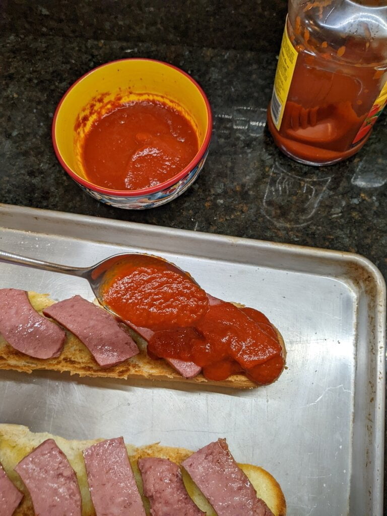 add tomato-based sauce on top of kielbasa