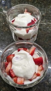 Add whipped cream to each cup for strawberry yogurt granola parfait recipe