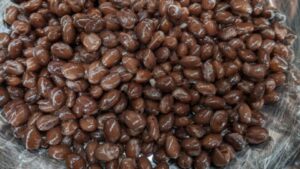 adding black beans into mixing bowl for chicken and saffron rice casserole recipe