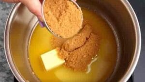 adding brown sugar to melted butter while making mustard and honey glaze recipe