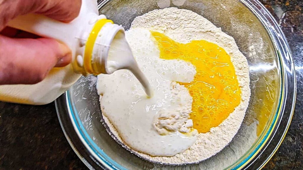 adding buttermilk to make the buttermilk cornbread muffins batter