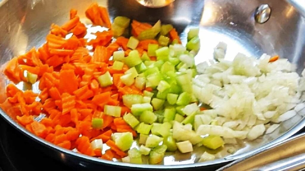 adding diced veggies to skillet for potatoes with green beans recipe