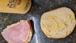 adding mustard to ham and cheese grilled sandwich recipe