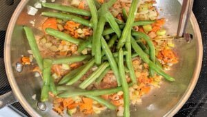 Adding oil to skillet for potatoes and green beans