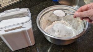 adding remaining ingredients to homemade pancake mix recipe