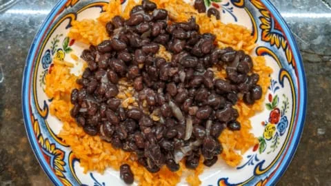 adding seasoned black beans to the best mexican rice recipe