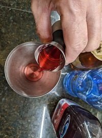 adding the measured red liquid to shaker