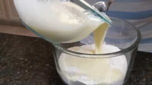 adding wet mixture into dry mix for old fashioned buttermilk pancakes recipe