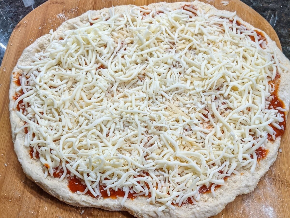 After cheeses added to sausage and pepperoni pizza