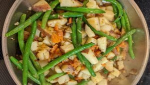 All ingredients added to skillet for potatoes and green beans