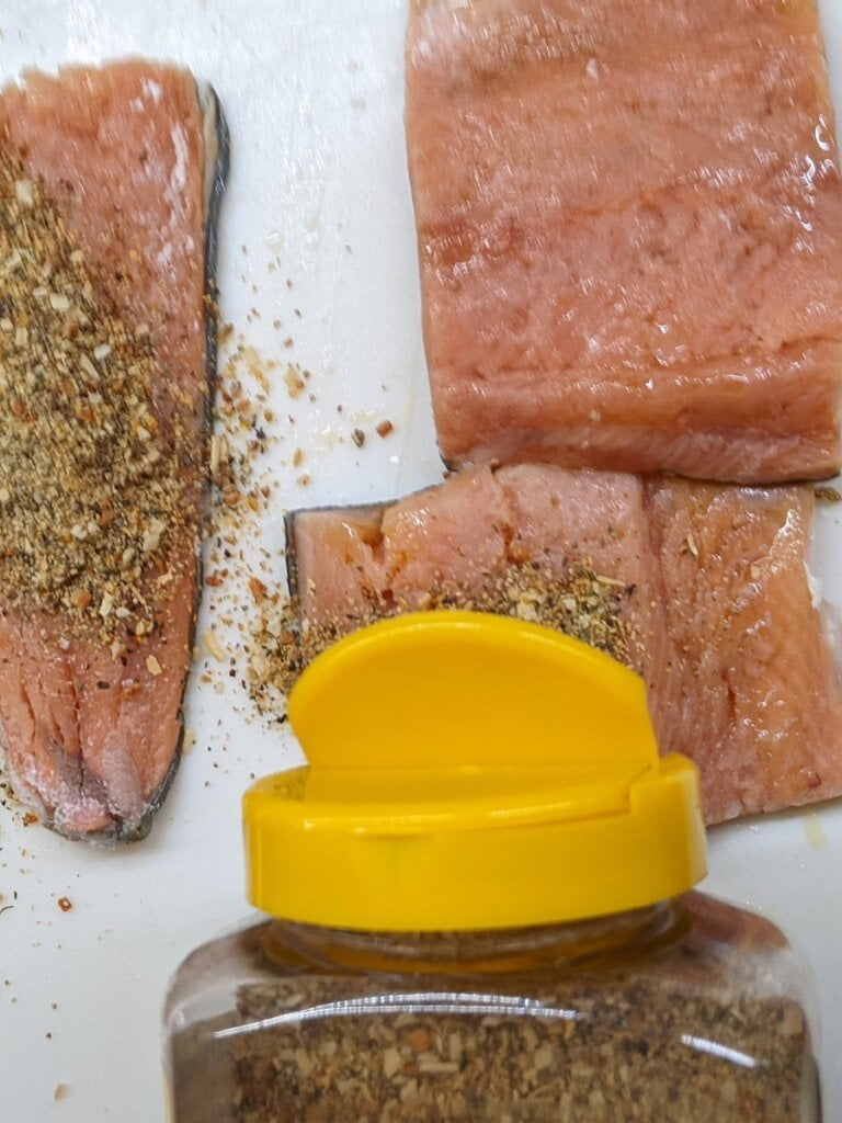 Applying Mrs. Dash onto salmon