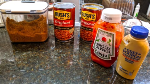 What to Add to Bush's Baked Beans for a Canned Beans Casserole Ingredients for what to add to Bush's baked beans casserole using canned beans laid out on a kitchen counter
