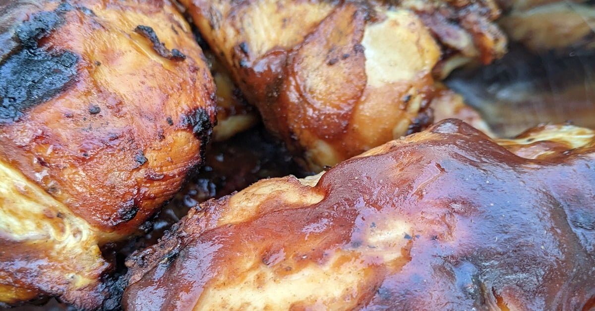 barbecued chicken on charcoal grill