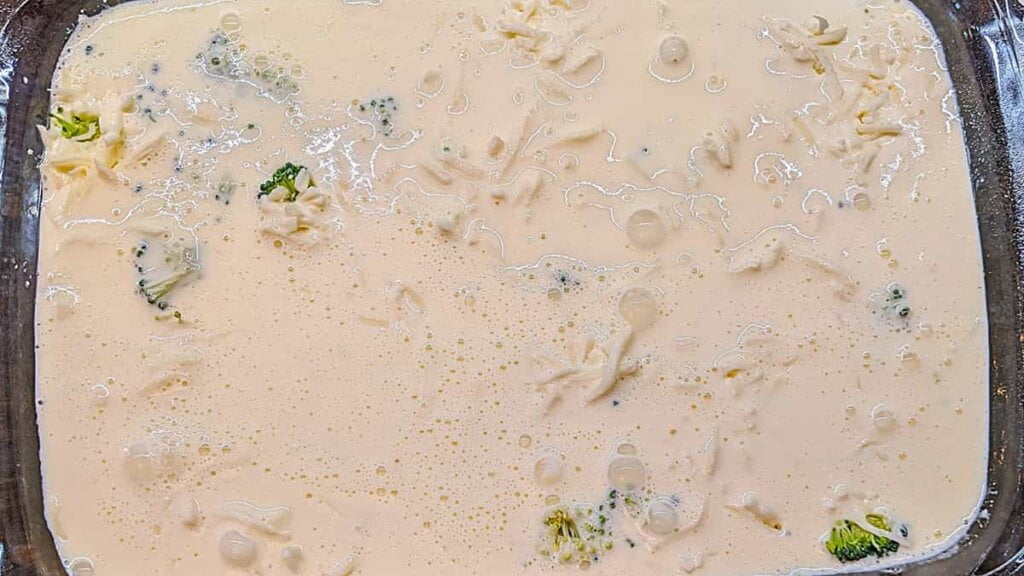 blended dairy ingredients poured on top of chicken broccoli quiche casserole