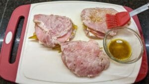 brushing coating onto meat for pan fried cuban stuffed pork chops recipe