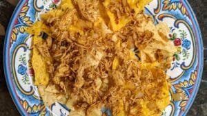 building chicken Nachos adding meat