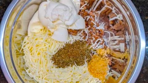 calzone ingredients ready to hand mix in mixing bowl