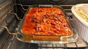 Baked beans casserole baking in the oven using canned beansBaked beans casserole baking in the oven using canned beans