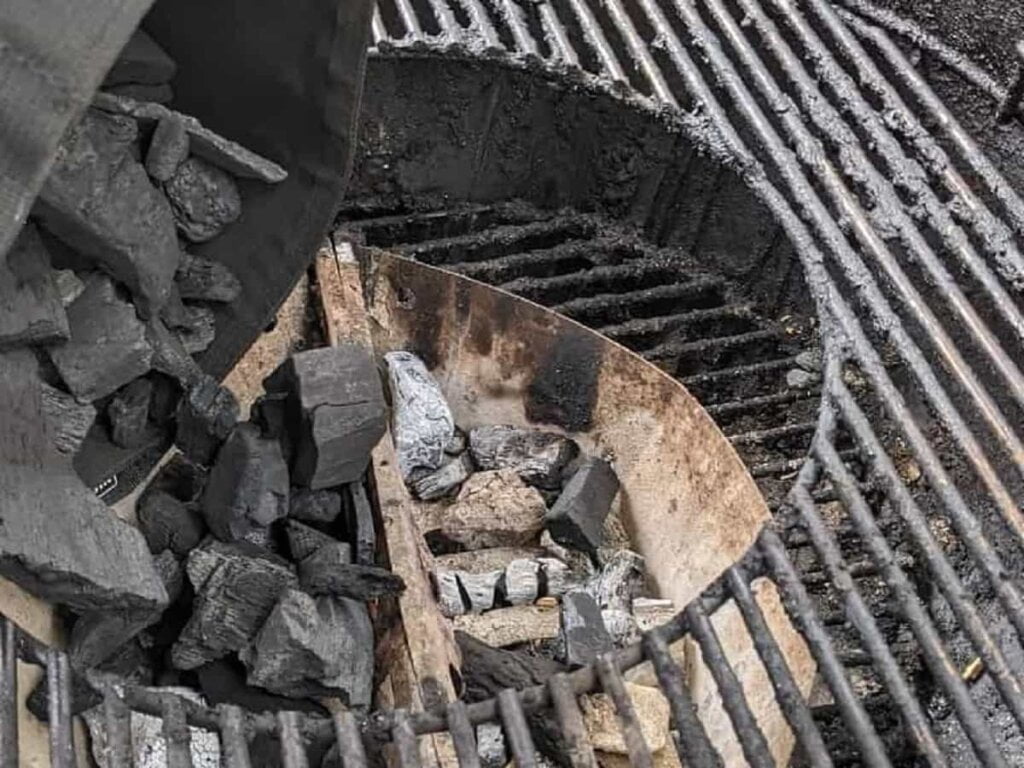 center of grill grate removed for refilling charcoal