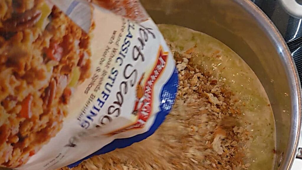 folding bread cubes into broth for stuffing