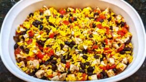 combined ingredients added to oiled casserole dish for chicken with saffron rice recipe