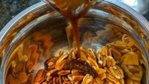 combining mixture with nuts for honey roasted pecans