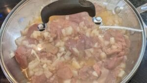cooking ingredients for chicken liver pate recipe in covered skillet