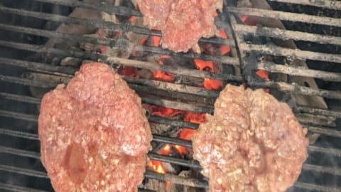 Cooking one side of frozen patties almost ready to turn cooking one side of frozen patties almost ready to turn