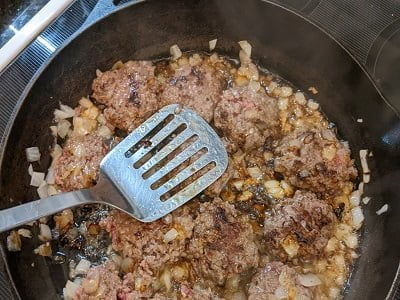 cooking small burgers in onions