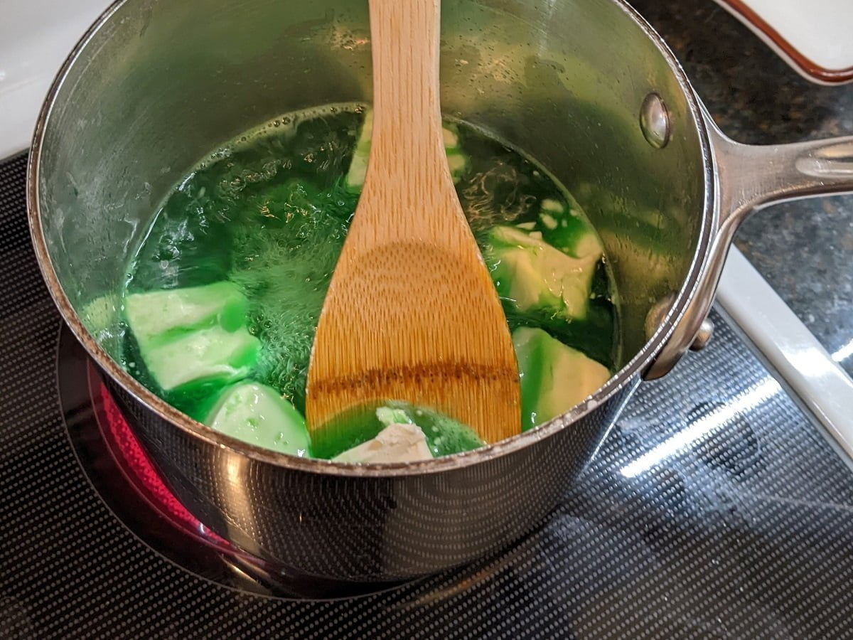 Cooking the added cream cheese for lime jello salad with pineapple and cream cheese