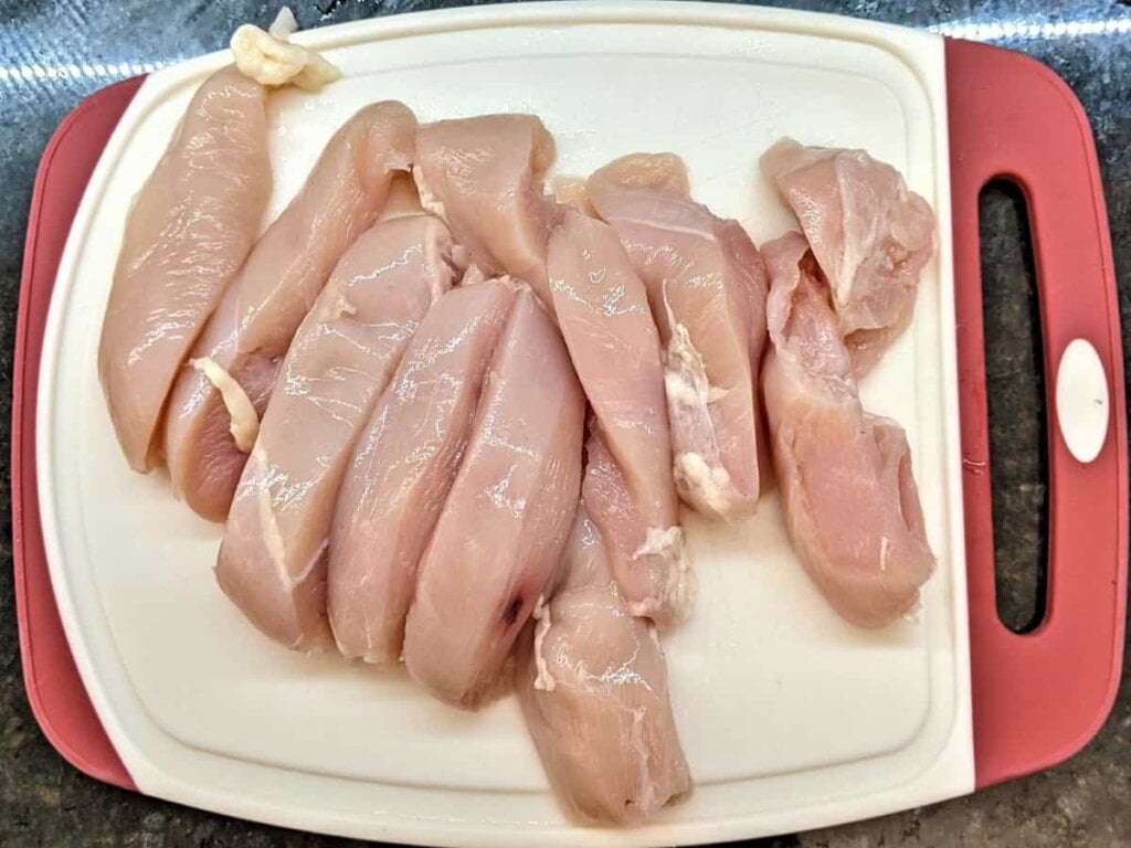 Cutting into 1 inch strips for recipe for crispy fried chicken strips