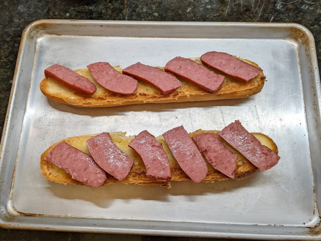 cut up and place preheated meat for open faced kielbasa sandwich