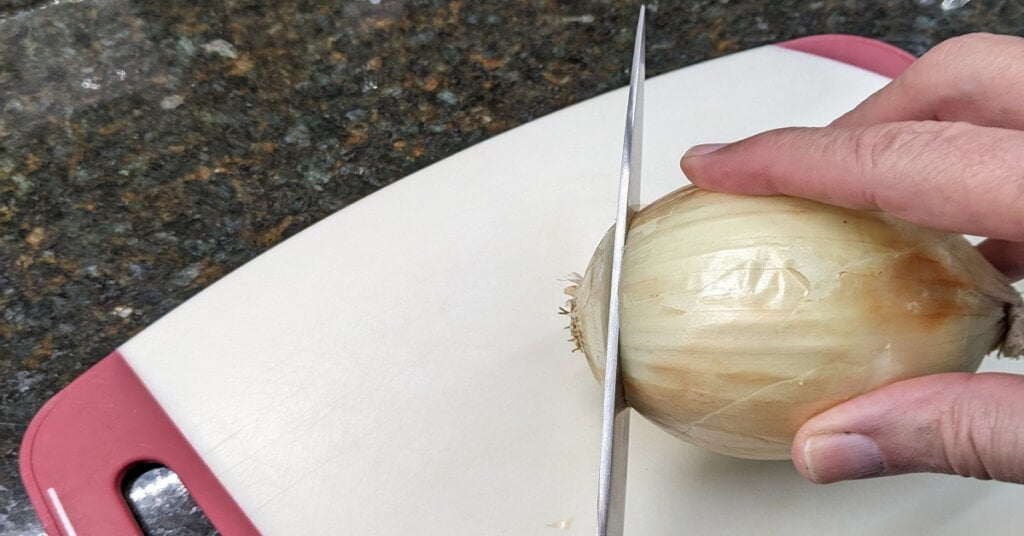 How to peel onions without crying - Cutting an end off how to peel onions without crying by cutting an end of an onion