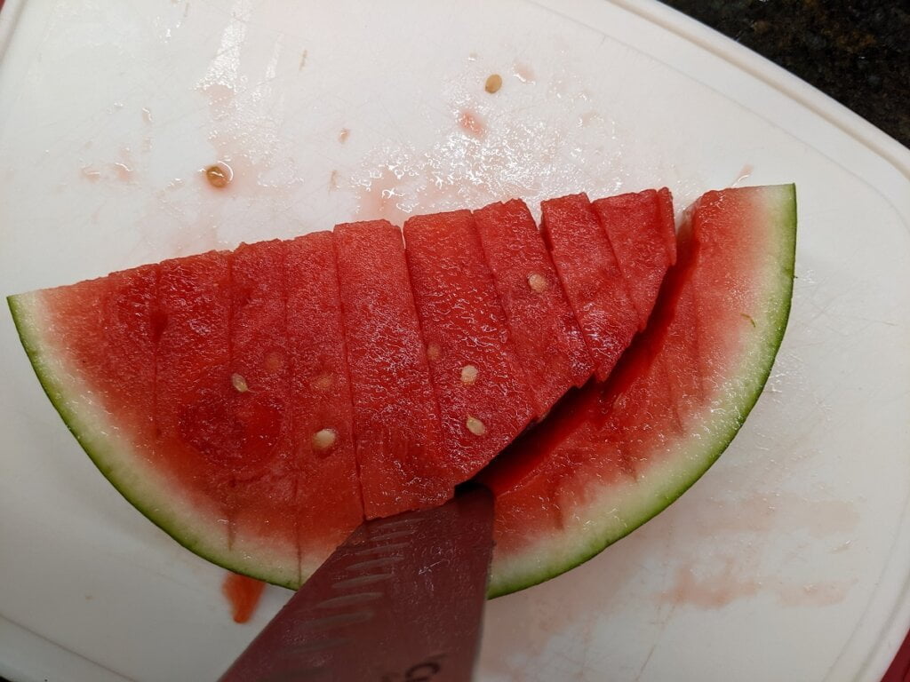 Cutting away the rind from watermelon columns cutting away the rind from watermelon columns