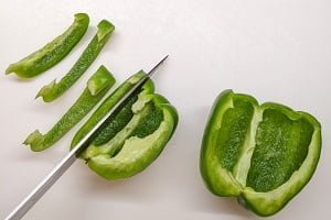 cutting bell peppers in strips for chicken fajitas