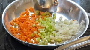 Diced veggies in pan for potatoes and green beans