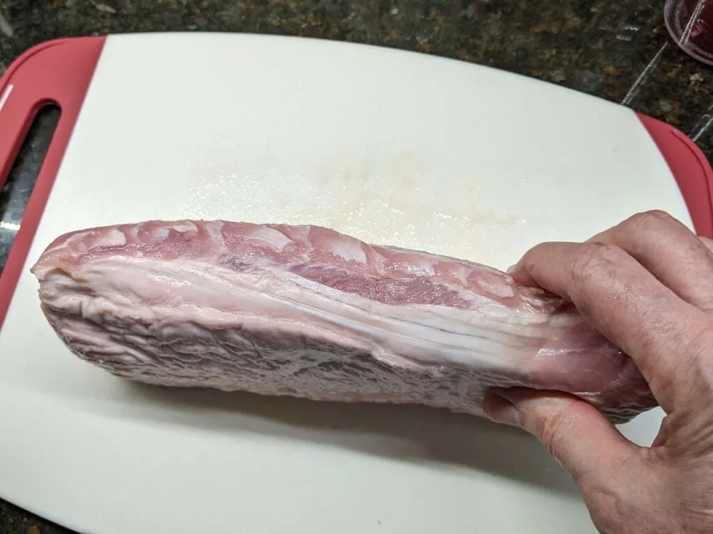 displaying fat side of pork tenderloin