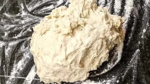 dough put onto floured surface for homemade pizzas oven baked