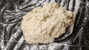 Dough put onto floured surface for pizza dough from bread machine