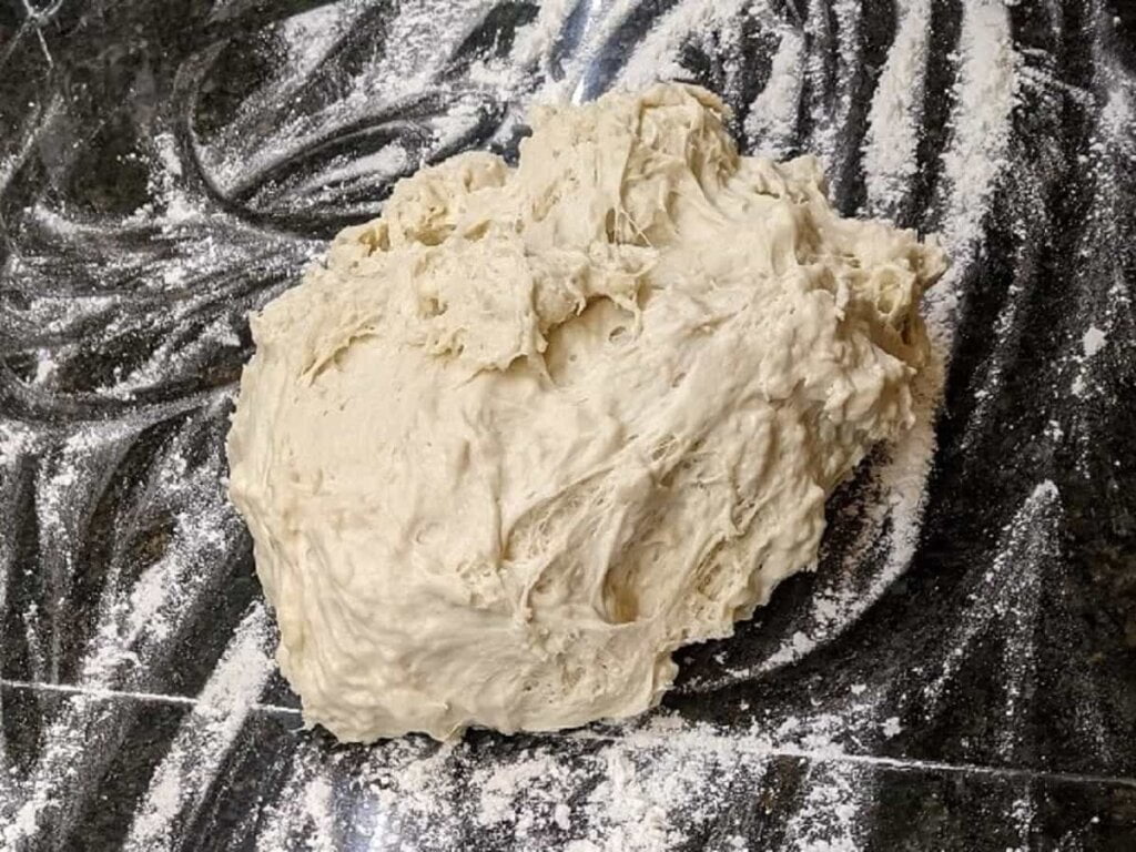 dough put onto floured surface for homemade sausage pepperoni pizza