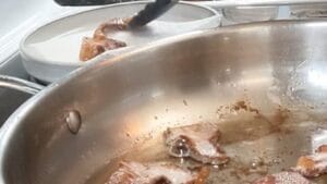 draining pan fried bacon on paper towels