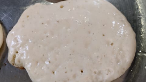 dry edges and popped bubbles show a pancake is ready to flip