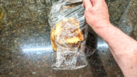 finishing sealing stack of pancakes to store using plastic wrap
