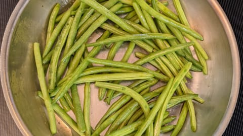 freshly snapped green beans added to hot fry pan for skillet green beans