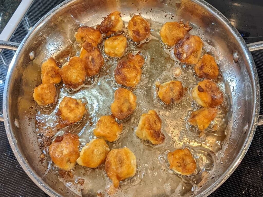 fried mushrooms ready to remove from frying pan